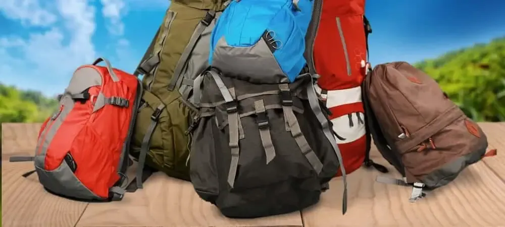 A pile of various backpacks in different colors and styles
