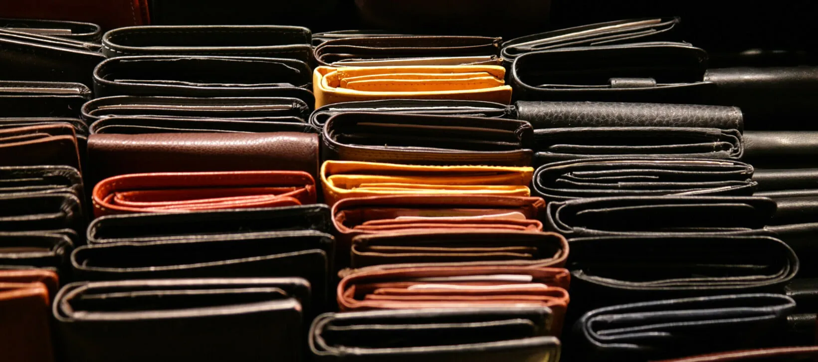 A collection of many different wallets in various styles and colors