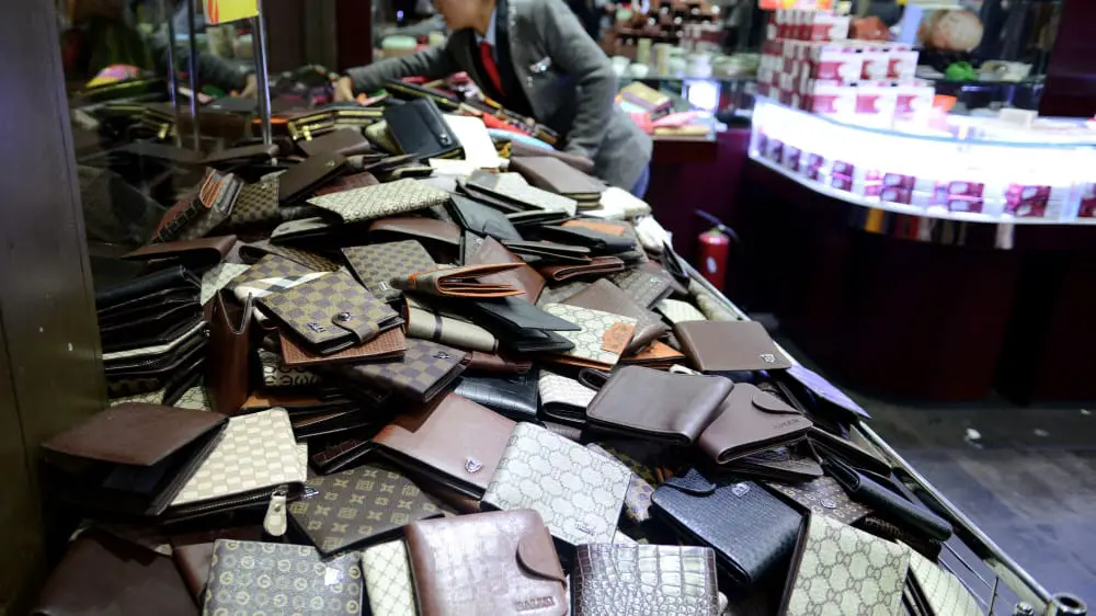 Article: How To Spot a Fake COACH Wallet or Bag Image: wallets in counterfeiting store