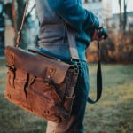 Article: Are Messenger Bags Bad for Your Back Image: closeup shot of a brown leather messenger bag