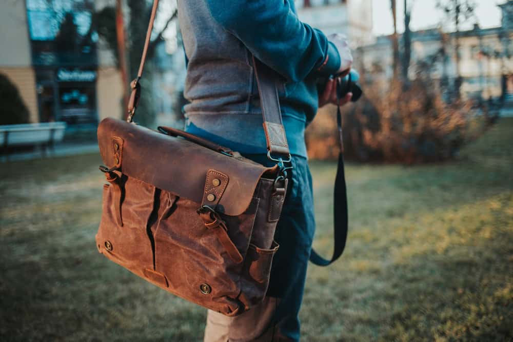 Article: Are Messenger Bags Bad for Your Back Image: closeup shot of a brown leather messenger bag