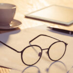 Article: "Spectacles, Testicles, Wallet and Watch". Image shows a pair of glasses, a coffee cup and an electronic tablet