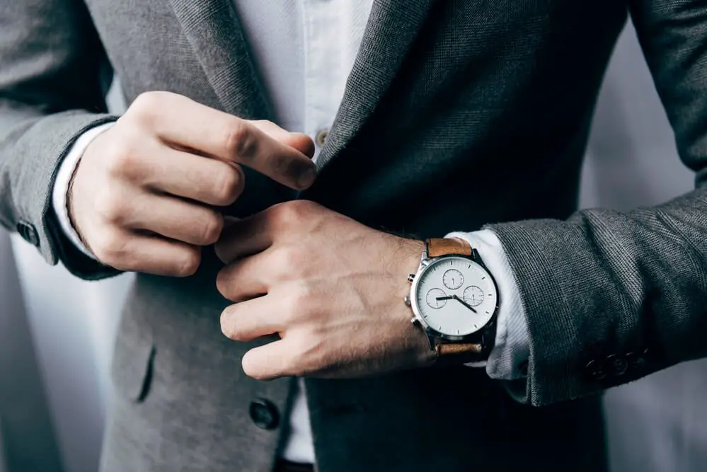 Which Hand Does A Watch Go On And What It Says About You   Man Adjusting Jacket Wearing Watch On Left Wrist 