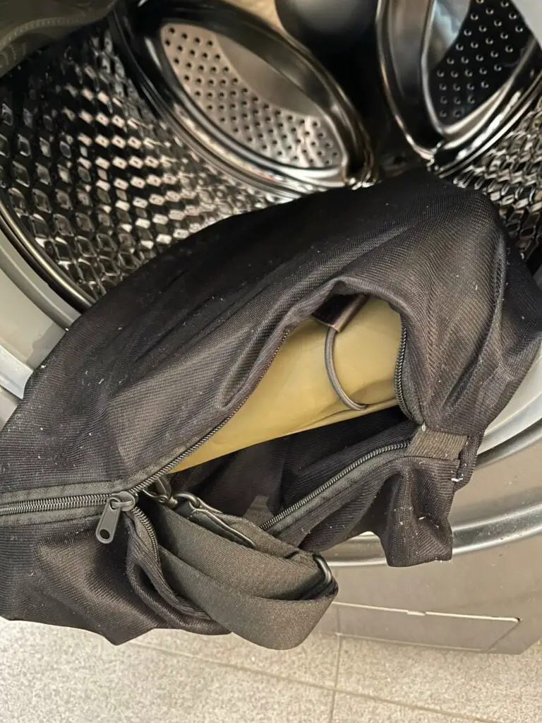 Messenger bag inside mesh bag inside washing machine